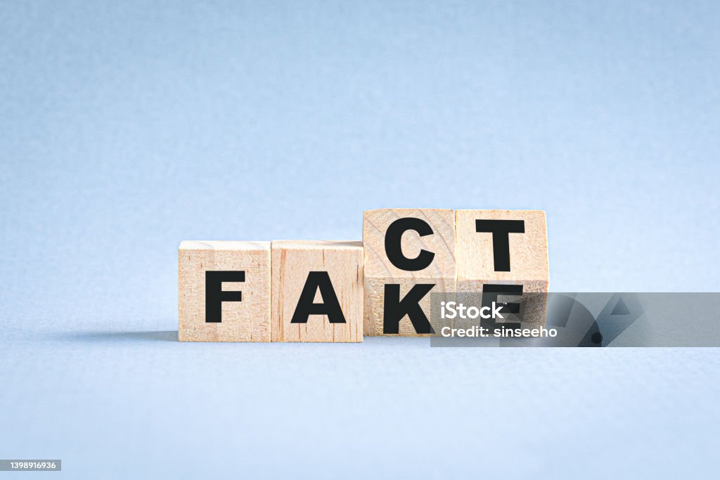 Fact or fake concept. Flipping wooden cubes block, from fact to fake wording. Honesty Stock Photo