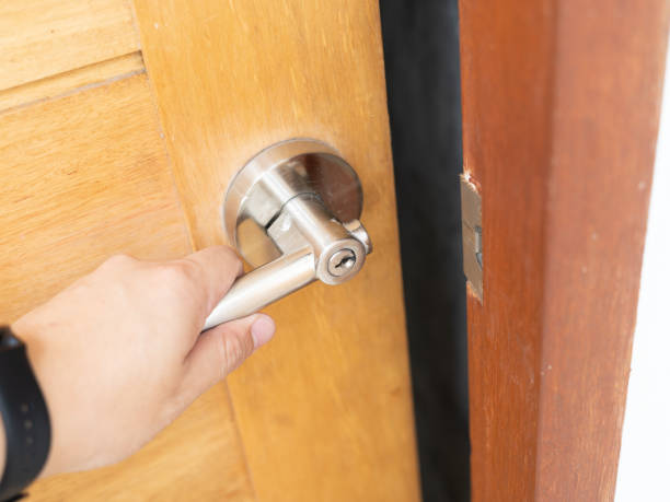istock hand hold handle of wood door. 1398917093