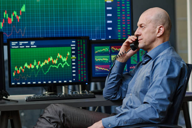istock Stock Trader Talking on Phone 1398920511