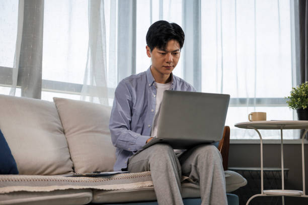 istock young asian man typing on laptop while working from home 1398925017