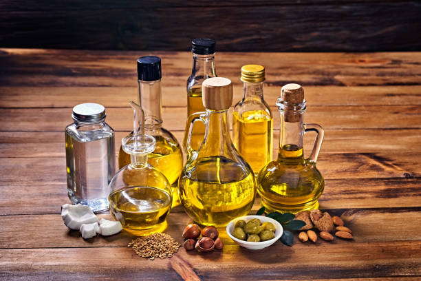 istock Assorted healthy vegetable oil bottle collection on wooden table in a old fashioned kitchen with low key illumination 1398926446