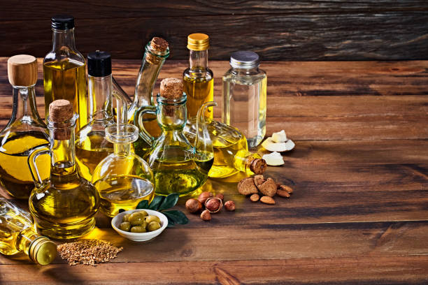 istock Assorted healthy vegetable oil bottle collection on wooden table in a old fashioned kitchen with low key illumination 1398926462
