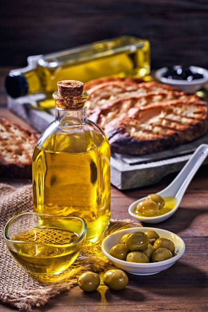 Snack or appetizer of garlic basil and olive oil bruschetta on table in a rustic kitchen stock photo