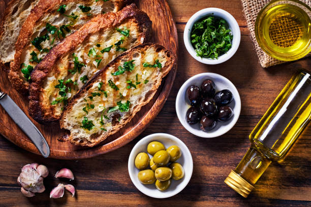 istock Snack or appetizer of garlic basil and olive oil bruschetta on table in a rustic kitchen 1398926651