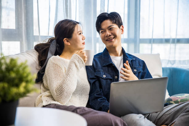 istock Young couple using laptop at home 1398927953