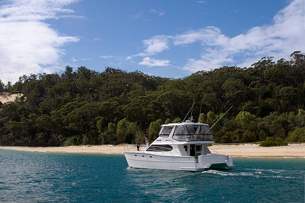 a yacht stops off at moreton island stock photo