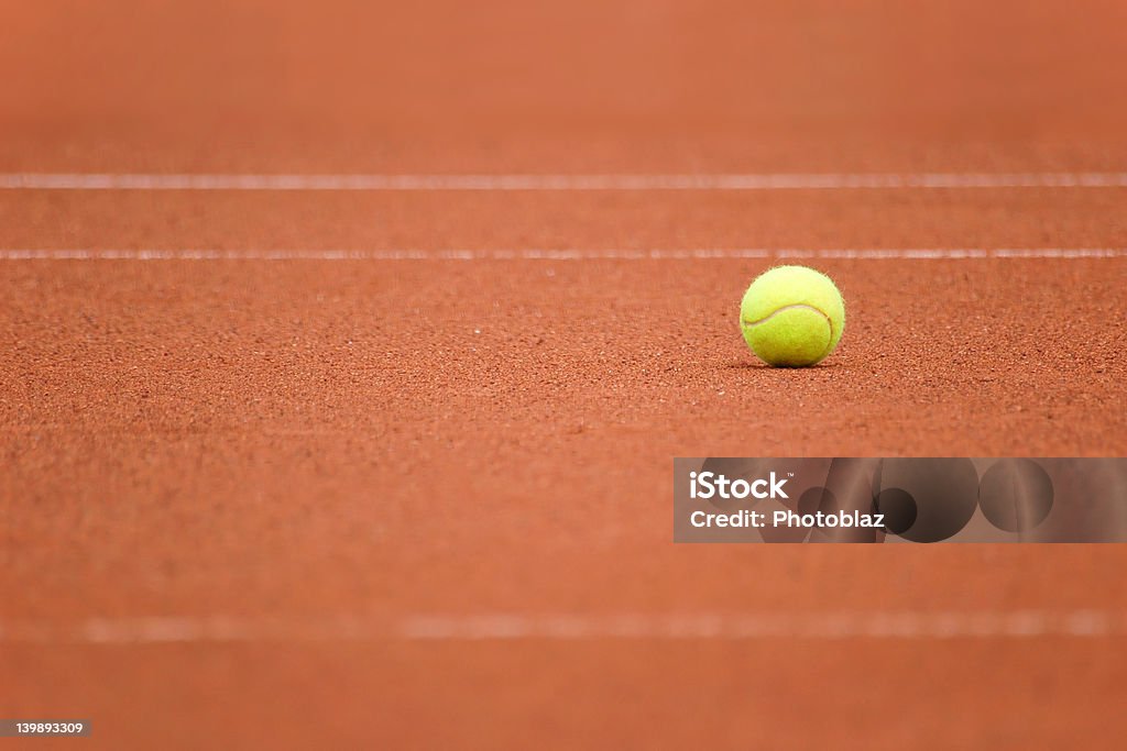 Tennis ball alone Tennis ball waiting to be picked up. Activity Stock Photo