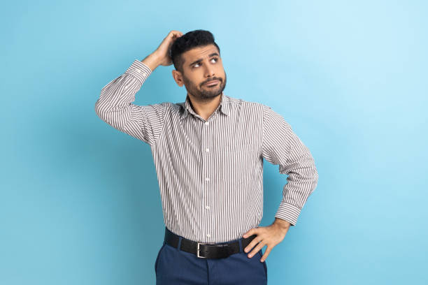 istock Pensive businessman with beard touching head and thinking about important question, making decision. 1398933915
