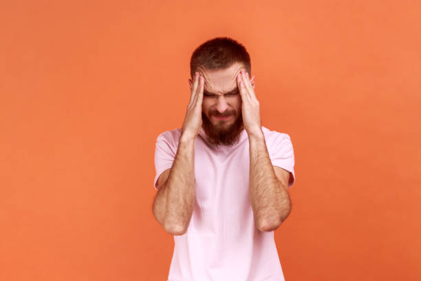 istock Unhealthy sick man massaging temples, suffering from headache, migraine. 1398934121
