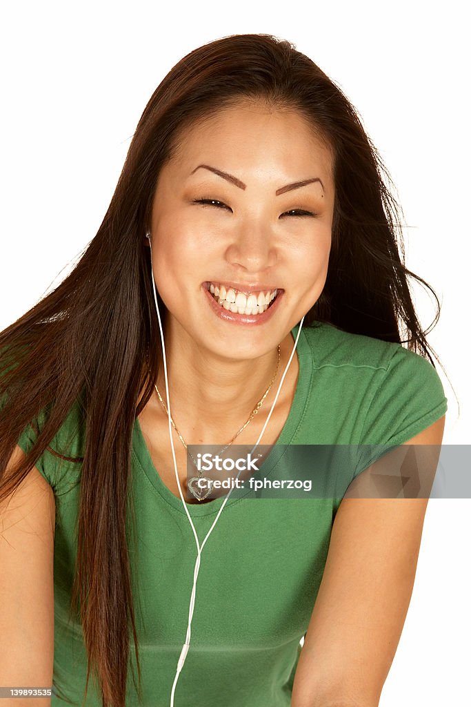 Śmiech Asian kobieta z wkładkami dousznymi - Zbiór zdjęć royalty-free (Beżowy)