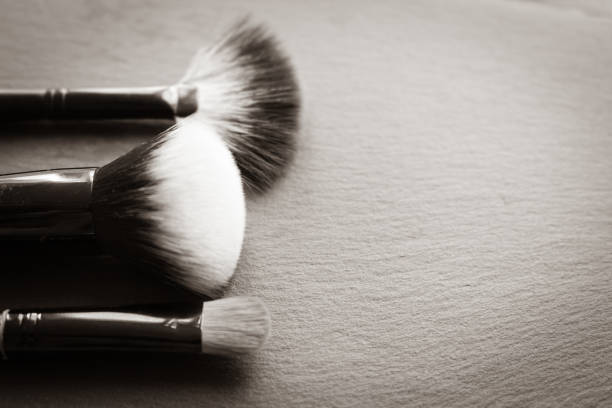 Makeup brush on black background with copy space. Beauty tools. Eye shadow brush. Cosmetics background. Beauty and fashion. Beauty device. Professional make up set.