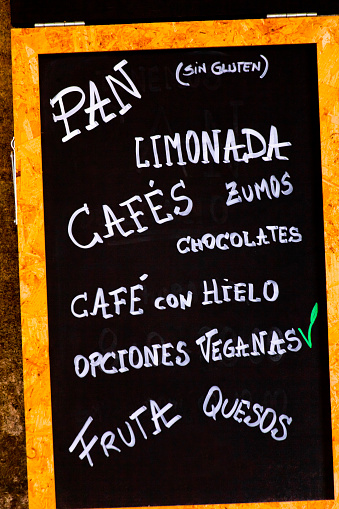 Cafeteria menu, chalk  handwriting on blackboard in spanish language. Coffees, chocolate,bread, lemonade, fruit juices. Seen in the street, Santiago de Compostela, Galicia, Spain.