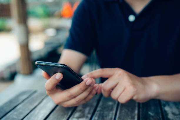 istock Close up of man hands with mobile phone. 1398939015