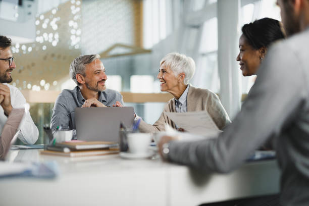 istock Happy entrepreneurs talking during a constructive meeting in the office. 1398939219