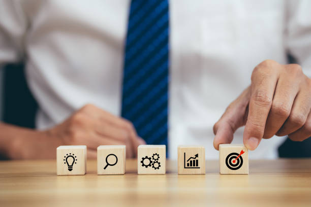 istock Businessman stack woods block step on table with icon business strategy and action plan. 1398939236