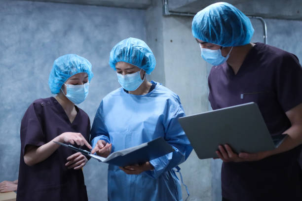 Surgeon and nurses having a meeting before operating on a client stock photo
