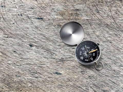 Compass on Vintage wood texture background. Travel destination and navigation concept