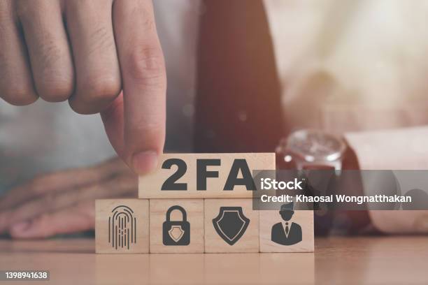 Businessman Pressing His Finger On The Wooden Blocks With Symbol Of 2fa Concept Two Factor Authorization Stock Photo - Download Image Now