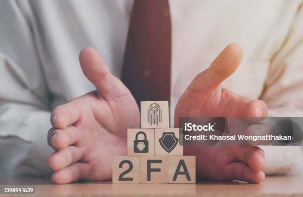 Businessman Pressing His Finger On The Wooden Blocks With Symbol Of 2fa Concept Two Factor Authorization Stock Photo - Download Image Now