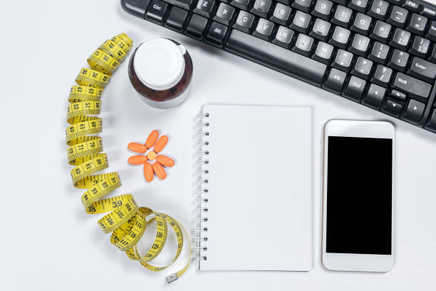 istock Tablets pills with notebook and mobile phone 1398944062