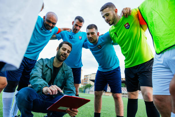 istock Coach giving instructions to the footbal team players 1398944149