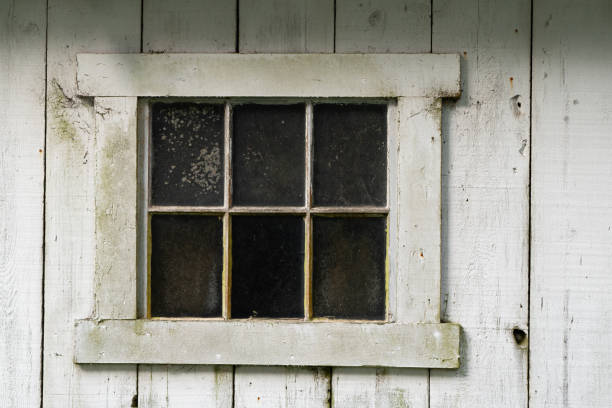 old antique window with weathered white wood boards stock photo