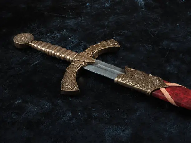 A beautiful antique sword with a bronze hilt and a leather sheath. On a dark abstract background.