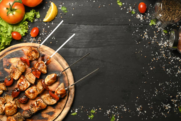istock Grilled meat and vegetables on wooden background. Top view with copy space. 1398948053