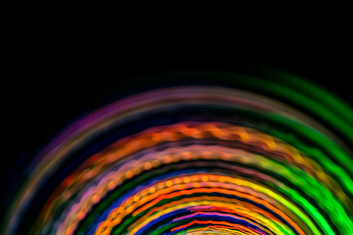 Abstract spinning multi colored lines with blurred motion effect. Can be used as some technological (science, information, data, etc.) background. Space for copy.