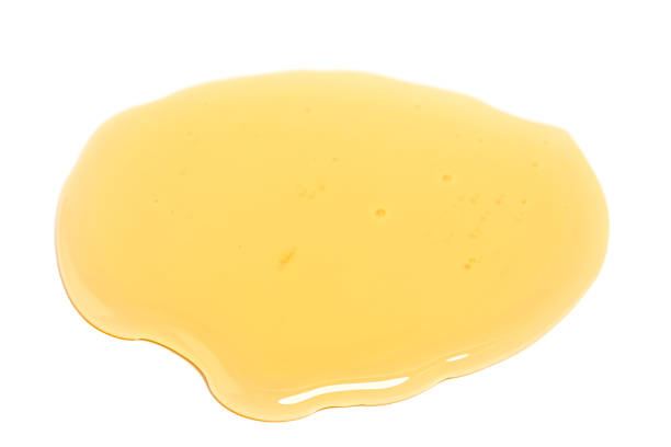 Puddle of honey isolated over white background. Puddle of honey isolated over white background beeswax wrap stock pictures, royalty-free photos & images
