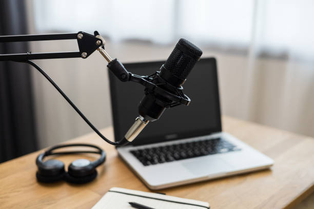 istock Condenser microphone in recording home studio. Content creator working with laptop host streaming radio podcast interview conversation at home broadcast studio recording voice over radio 1398952798