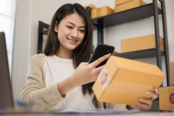 istock Startup Small business owner entrepreneur woman using smartphone scan qr code on product checking stock. Online business working at home. Contact customer on social network 1398952951