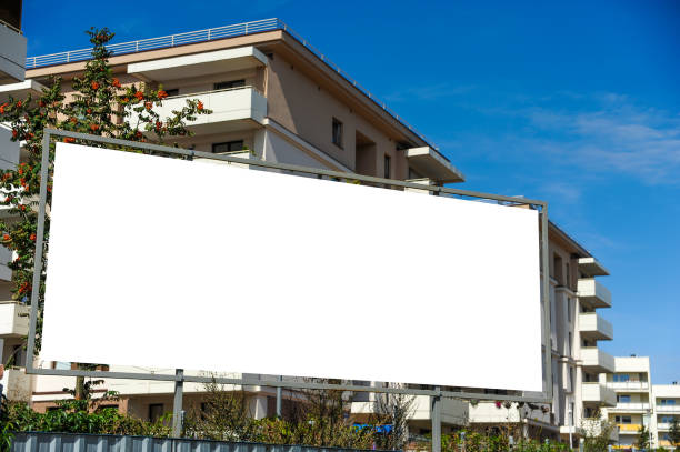 istock Blank white advertising billboard in front of the building 1398953130