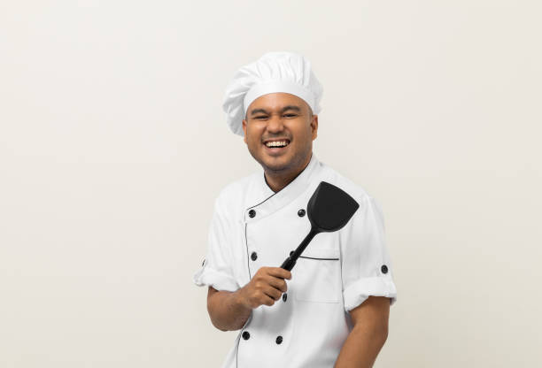 istock Young handsome asian man chef in uniform standing with turner kitchen utensils various gesture action on isolated background. Cooking man Occupation chef People in kitchen restaurant and hotel. 1398953144