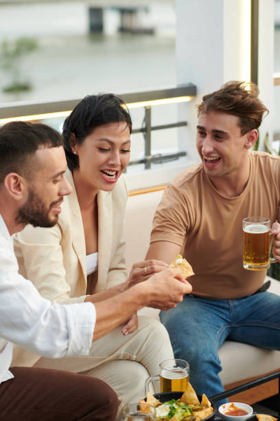 istock Friends Eating Tortilla Chips with Hot Sauce 1398954021