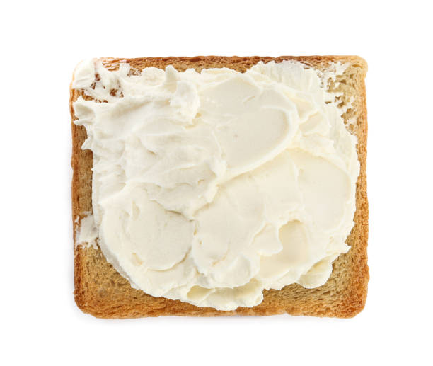 istock Toasted bread with cream cheese isolated on white, top view 1398954281
