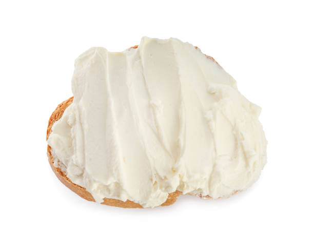 istock Toasted bread with cream cheese isolated on white, top view 1398954295