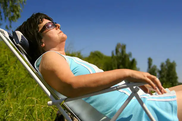 A woman sitting in the sun.