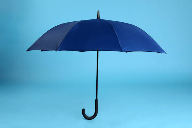 istock Stylish open bright umbrella on light blue background 1398954683