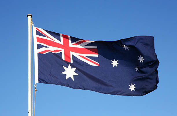 Waiving Australian flag on blue background