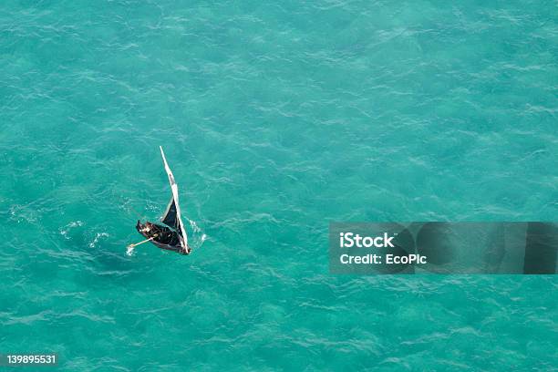 Small Sailboat On A Teal Sea In Mozambique Africa Stock Photo - Download Image Now - Mozambique, Breaking Wave, Sea