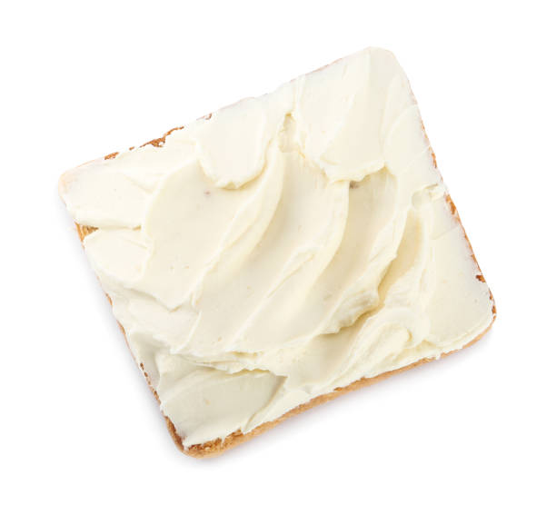 istock Toasted bread with cream cheese isolated on white, top view 1398955600