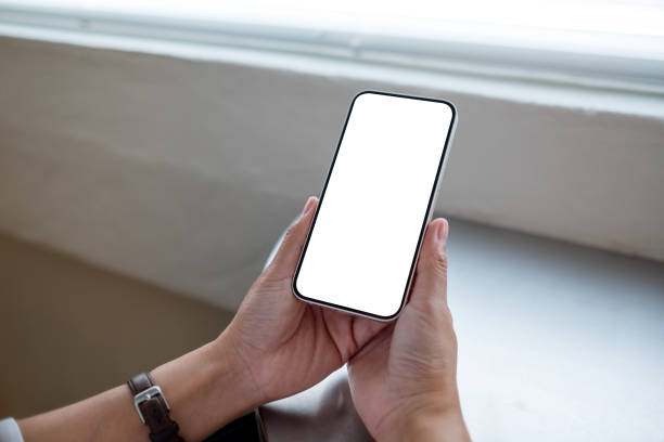 istock Mockup image of a woman holding mobile phone with blank desktop screen 1398955689