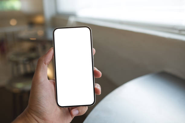 istock Mockup image of a man holding mobile phone with blank white screen in cafe 1398955690