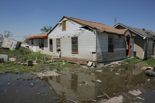 After hurricane Katrina in the Ninth Ward of New Orleans. The homes seen here originally sat a block or more away.  The powerful flood waters of the levy failure picked up and deposited these homes ontop of other homes. The devestation and loss in this section of New Orleans is beyond words.