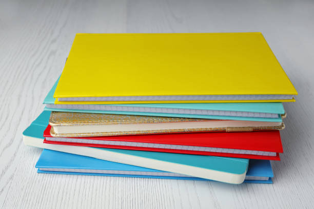 istock Stack of colorful planners on white wooden table 1398957240