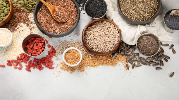 istock Variety of edible seeds on light background. 1398958067