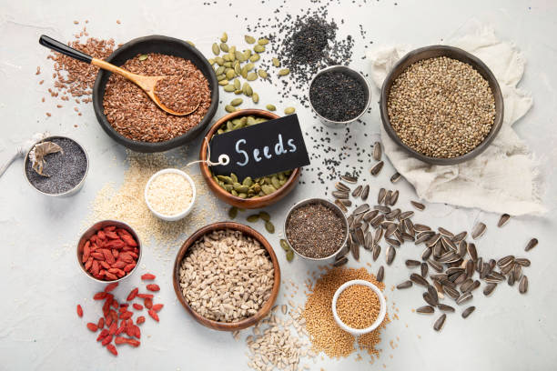 istock Variety of edible seeds on light background. 1398958068