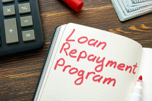 istock Loan repayment program inscription on the page and calculator. 1398958086