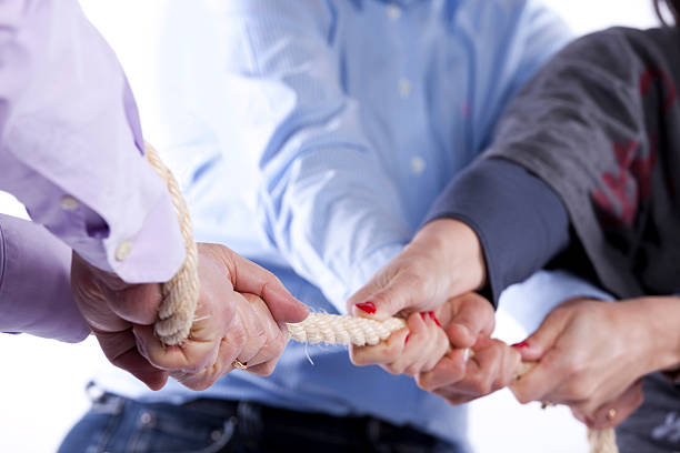 istock A game to tug-of-war between three people 139895886